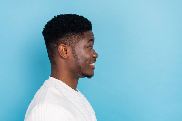 Profile side photo of cheerful young man look copyspace with cool hairstyle after barber isolated on blue color background. - Foto, Imagem