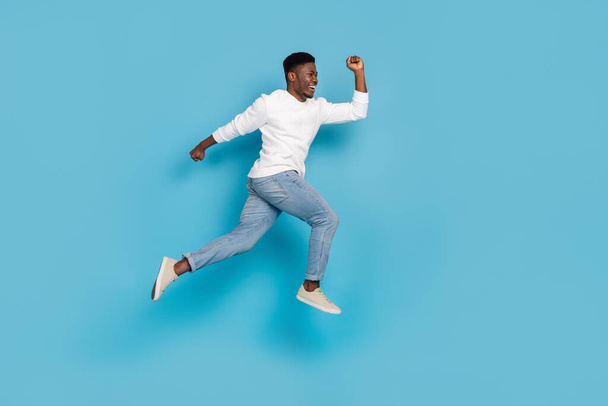 Full body portrait of excited person hurry rush look empty space isolated on blue color background. - Photo, image