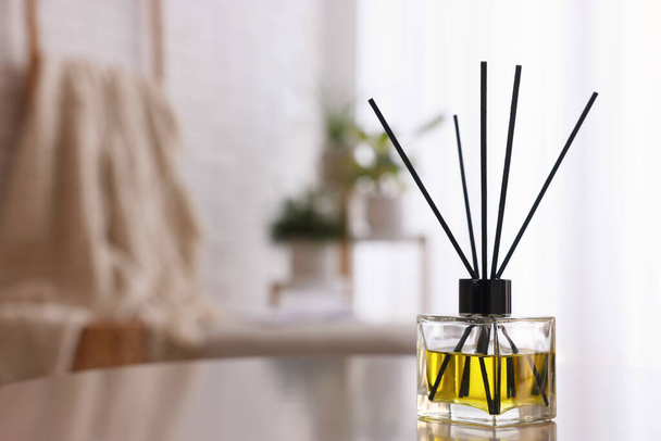 Reed diffuser on white table indoors. Space for text - Foto, Imagem