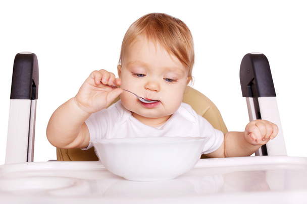 Παιδικές τροφές. Μωρό τρώει από τον εαυτό του  - Φωτογραφία, εικόνα