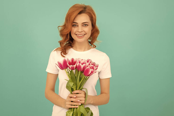 happy woman with tulip flower bouquet on blue background. - Photo, Image