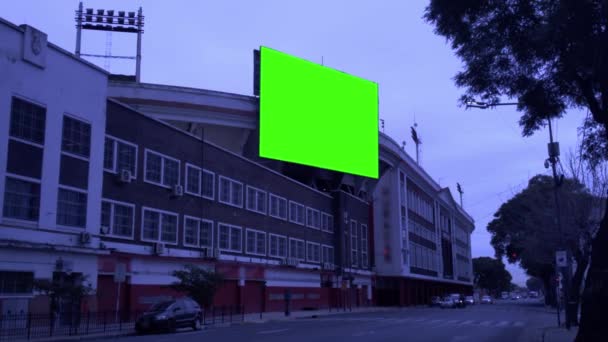 Chroma Key Green Screen Billboard, Large Billboard with Green Screen near a Soccer Stadium in the City. Zoom In. 4K Resolution. - Imágenes, Vídeo