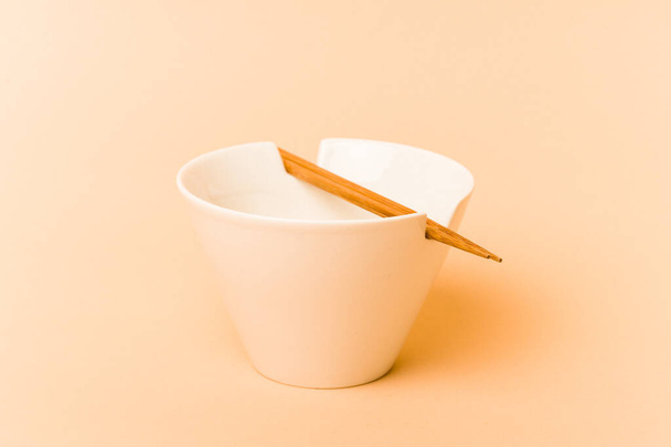 White noddles bowl with chopstick isolated on beige background - Photo, Image