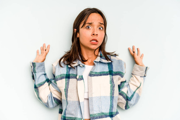 Young hispanic woman isolated on blue background showing a welcome expression. - Photo, Image