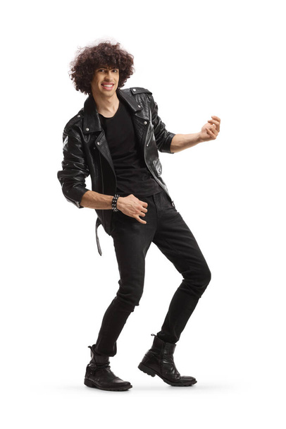 Cheerful young man in a leather jacket pretending to play a guitar isolated on white background - Foto, afbeelding