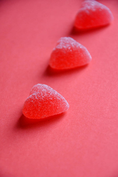 Photo of red jelly candy hearts on red background - Photo, Image