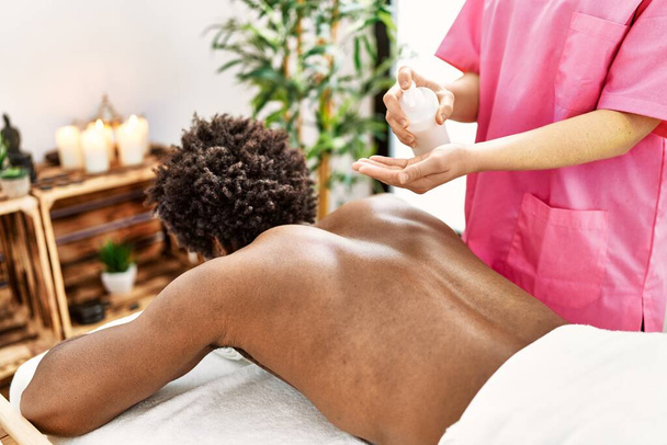 Young african american man having massage at beauty center - Foto, imagen
