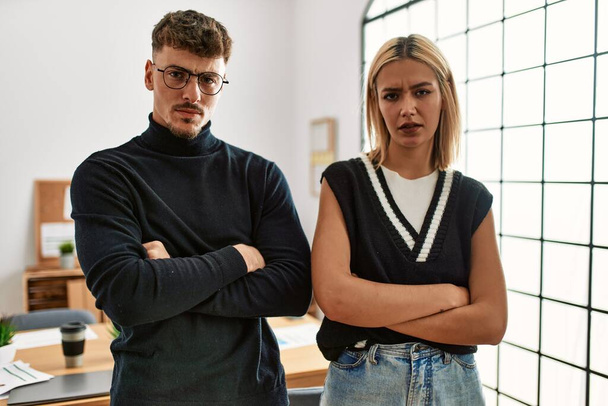 Two beautiful business workers wearing business style standing at the office skeptic and nervous, disapproving expression on face with crossed arms. negative person.  - Fotoğraf, Görsel