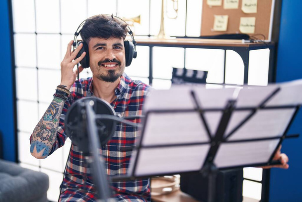 Young hispanic man artist singing song at music studio - Foto, imagen