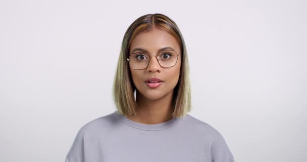 4k video footage of a beautiful young woman looking surprised while standing against a white background. - Záběry, video