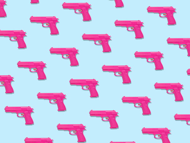 Colorful pastel pattern made of pink handguns. Minimal creative concept. - Фото, изображение