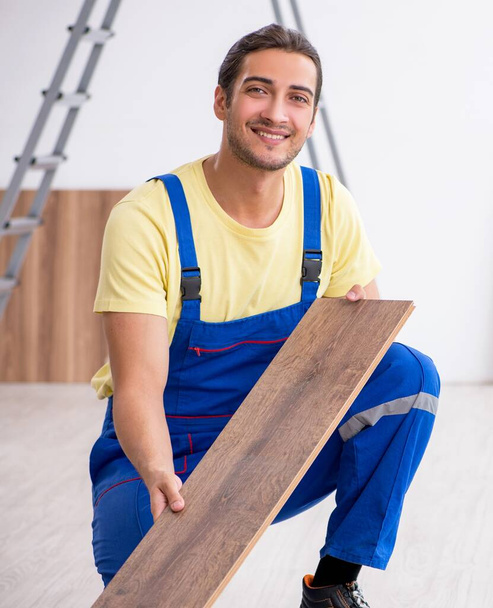 The young male contractor working indoors - Photo, Image
