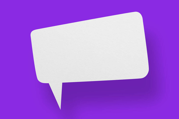 Weißes Papier in Form von Sprechblasen vor violettem Hintergrund. Kommunikationsblasen. - Foto, Bild