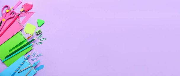 Many school stationery on lilac background with space for text, top view - Foto, Imagen