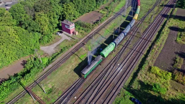 Aerial view from flying drone of colorful freight trains on the railway station - Filmmaterial, Video