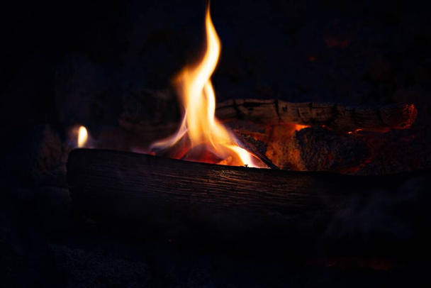 A closeup shot of a burning flame in a dark room - Photo, image