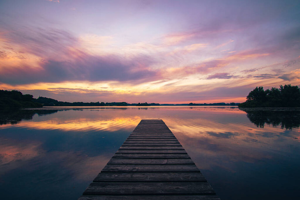 Colorful sunset over beautiful calm lake. High quality photo - Фото, изображение