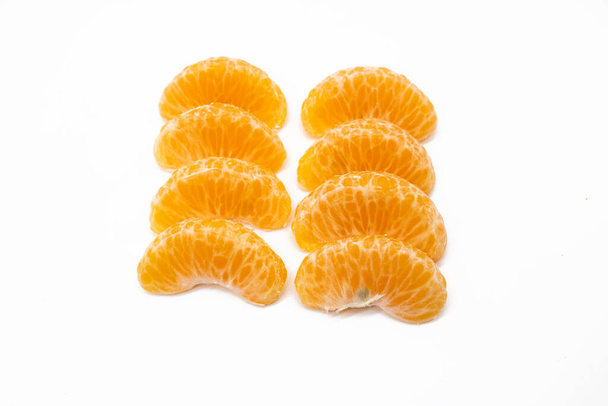 some pieces of tangerine isolated on white background - Foto, afbeelding