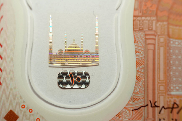 Colorful watermark of the administrative capital's grand mosque Al-Fattah Al-Aleem in Egypt from the obverse side of the new first Egyptian 10 LE EGP ten pounds plastic polymer banknote series 2022 - Photo, Image