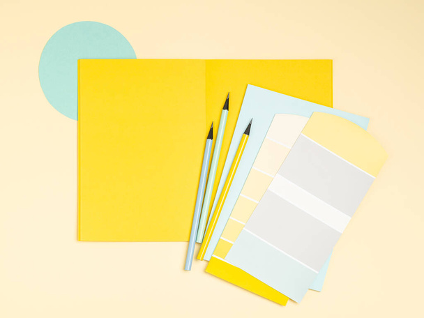 Simple, bright and colourful artists, designers workplace background with place for text. Colour samples palette, notebook, pens, pencils frame for people of creative professions and students. - Foto, afbeelding