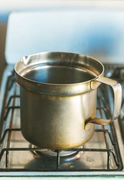closeup of old saucepan on gas cooker - Foto, Imagen