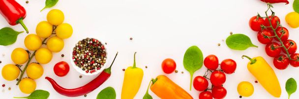 Yellow and red tomatoes, hot peppers,spinach and spices on a white background, food banner, top view, copy space - Φωτογραφία, εικόνα
