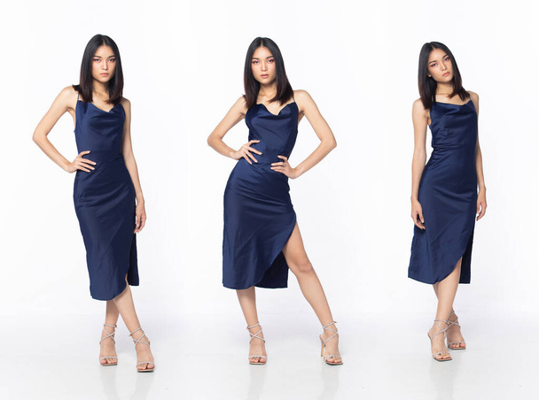 Ganzer Körper der asiatischen schönen Frau tragen blaue Abendkleid mit Pailletten, junge weibliche Stand ausdrücken Gefühl glückliches Lächeln über weißem Hintergrund isoliert - Foto, Bild