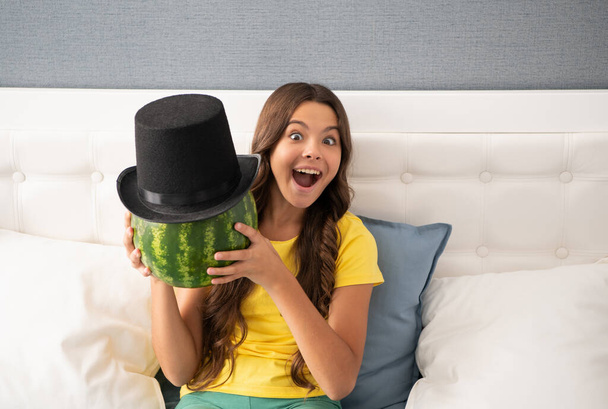 kid with fruit. healthy food for children. fructose healthy eating on summer vacation. teen girl having fun. summertime. surprised child hold water melon. watermelon in summer cylinder hat. - Photo, Image
