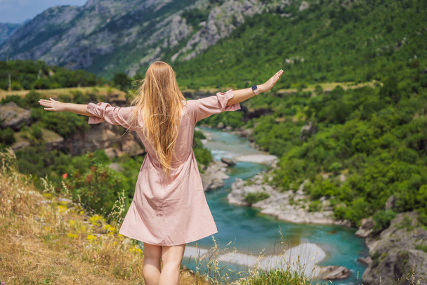 Woman tourist on background of purest waters of the turquoise color of the river Moraca flowing among the canyons. Travel around Montenegro concept. - Foto, Imagem