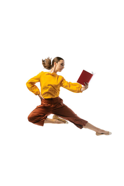 Office ballet. Studio shot of graceful young girl in action, motion isolated on white background. Business, start-up, working open-space, professional occupation concept. Copy space for ad - Foto, imagen