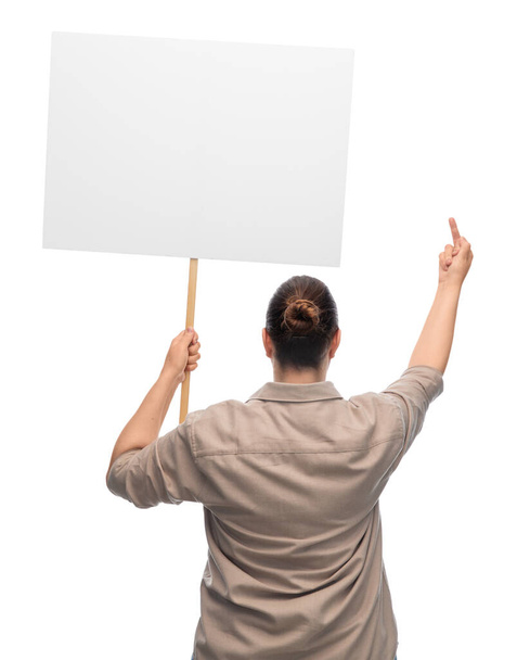 feminism and human rights concept - woman with poster protesting on demonstration and showing middle finger over white background - Photo, Image
