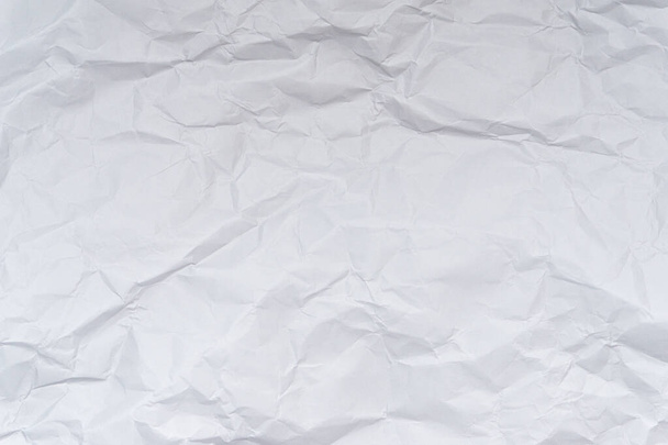 A mess of crumpled paper trash on a black background - Фото, изображение
