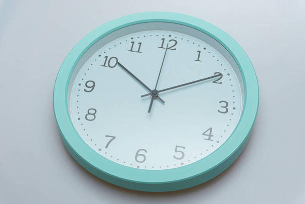 Wall clock showing various times on a white background - Zdjęcie, obraz
