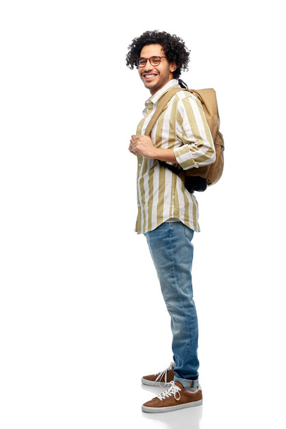 travel, fashion and education concept - happy smiling man in glasses with backpack over white background - Foto, Imagen