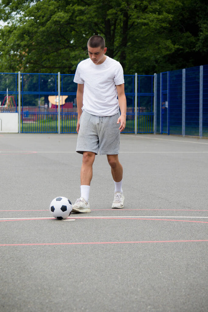 A Nineteen Year Old Teenage Boy Playing Football in A Public Park - Fotoğraf, Görsel