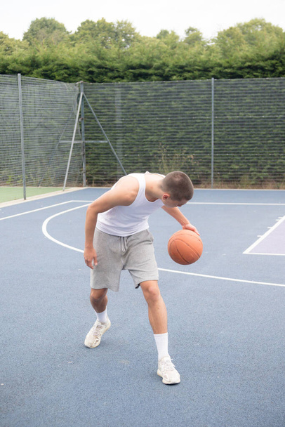 A Nineteen Year Old Teenage Boy Playing Basketball in A Public Park - Photo, Image