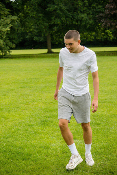 A Nineteen Year Old Teenage Boy Playing Football in A Public Park - Fotografie, Obrázek
