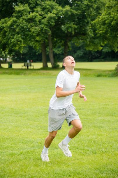A Nineteen Year Old Teenage Boy Playing Football in A Public Park - Fotografie, Obrázek