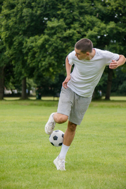 A Nineteen Year Old Teenage Boy Playing Football in A Public Park - Zdjęcie, obraz
