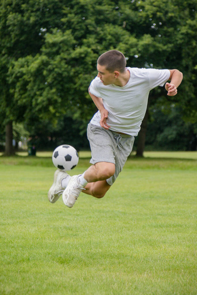 A Nineteen Year Old Teenage Boy Playing Football in A Public Park - Zdjęcie, obraz