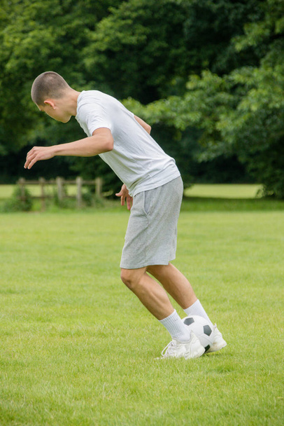 A Nineteen Year Old Teenage Boy Playing Football in A Public Park - Photo, Image
