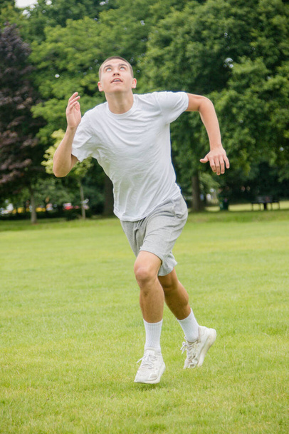 A Nineteen Year Old Teenage Boy Playing Football in A Public Park - Fotó, kép