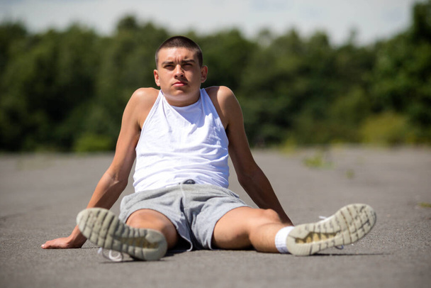 A Nineteen Year Old Teenage Boy Sitting in A Public Park - Valokuva, kuva