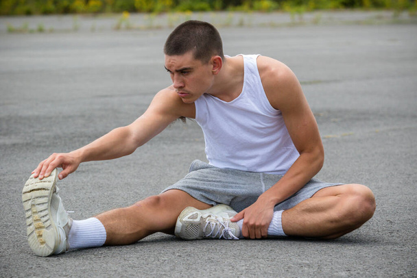 A Nineteen Year Old Teenage Boy Stretching In A Public Park - Zdjęcie, obraz