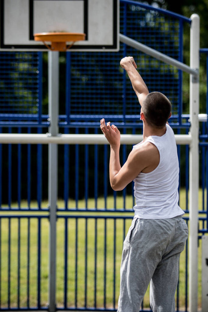 A Nineteen Year Old Teenage Boy Shooting A Hoop in A Basketball Court in A Public Park - Fotoğraf, Görsel