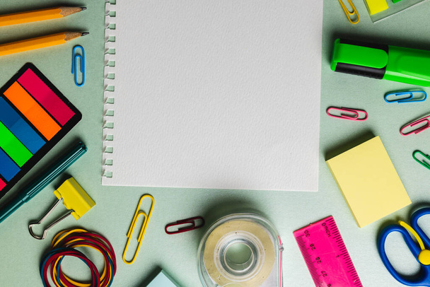 Composition of notebook with copy space and school tools on green surface. School equipment, tools and creativity concept. - Foto, imagen
