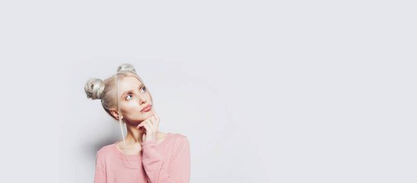 Studio portrait of pretty blonde girl looking up. Panoramic banner, copy space. - Foto, immagini