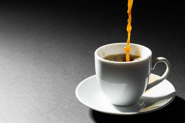Image of white cup of hot black coffee on black background. Coffee, refreshment and beverages. - Foto, Bild