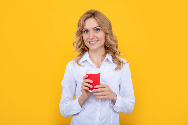 happy blond woman with coffee cup on yellow background. - Fotoğraf, Görsel