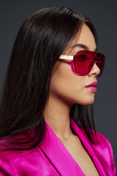 woman posing pink mini dress charm sunglasses isolated background. High quality photo - Photo, Image